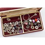 A SMALL TRAVEL JEWELLERY BOX WITH CHARMS, burgundy jewellery box filled with white metal and glass