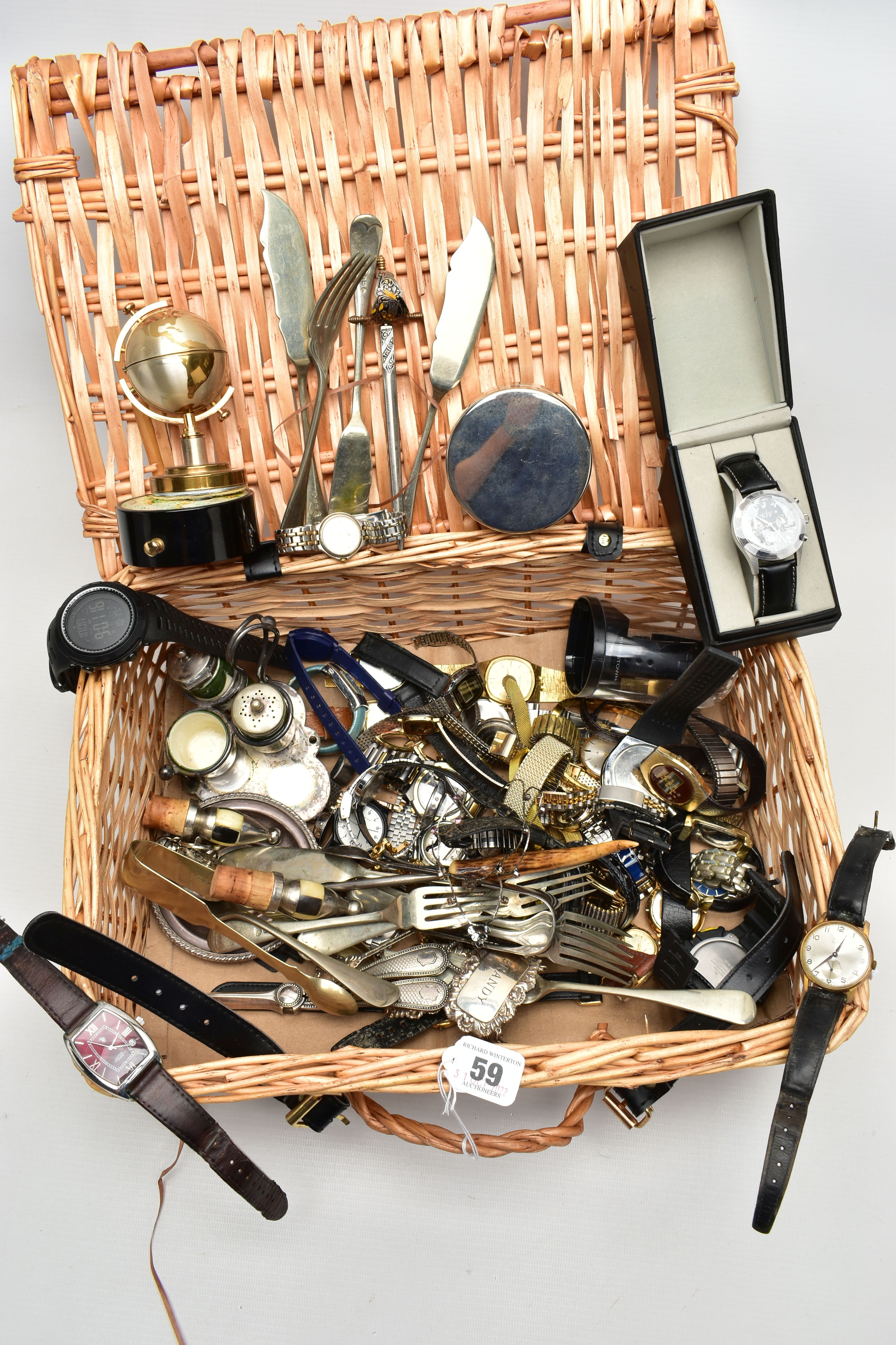 A WICKER BASKET WITH ITEMS, items to include various ladies and gents fashion wristwatches mostly