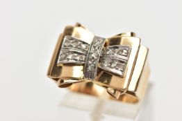 A YELLOW METAL AND DIAMOND DRESS RING, designed as a large bow, fifteen rose cut diamonds set into a