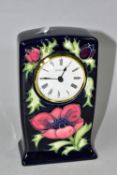 A MOORCROFT POTTERY MANTEL CLOCK OF RECTANGULAR FORM, decorated with red / purple anemone on a