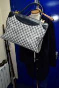 A TORY BURCH LADIE'S MID LENGTH JACKET TOGETHER WITH A VINTAGE TRAVEL BAG, the jacket is navy blue