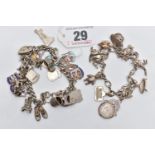 TWO SILVER CHARM BRACELETS, the first fitted with eleven charms in forms such as a kangaroo, cat,