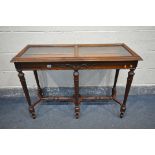 A REPRODUCTION OAK BIJOUTERIE TABLE, hinged lid with two beveled glass panes, carved detailing to