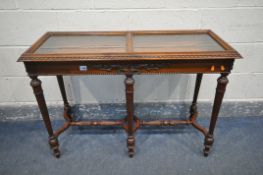 A REPRODUCTION OAK BIJOUTERIE TABLE, hinged lid with two beveled glass panes, carved detailing to