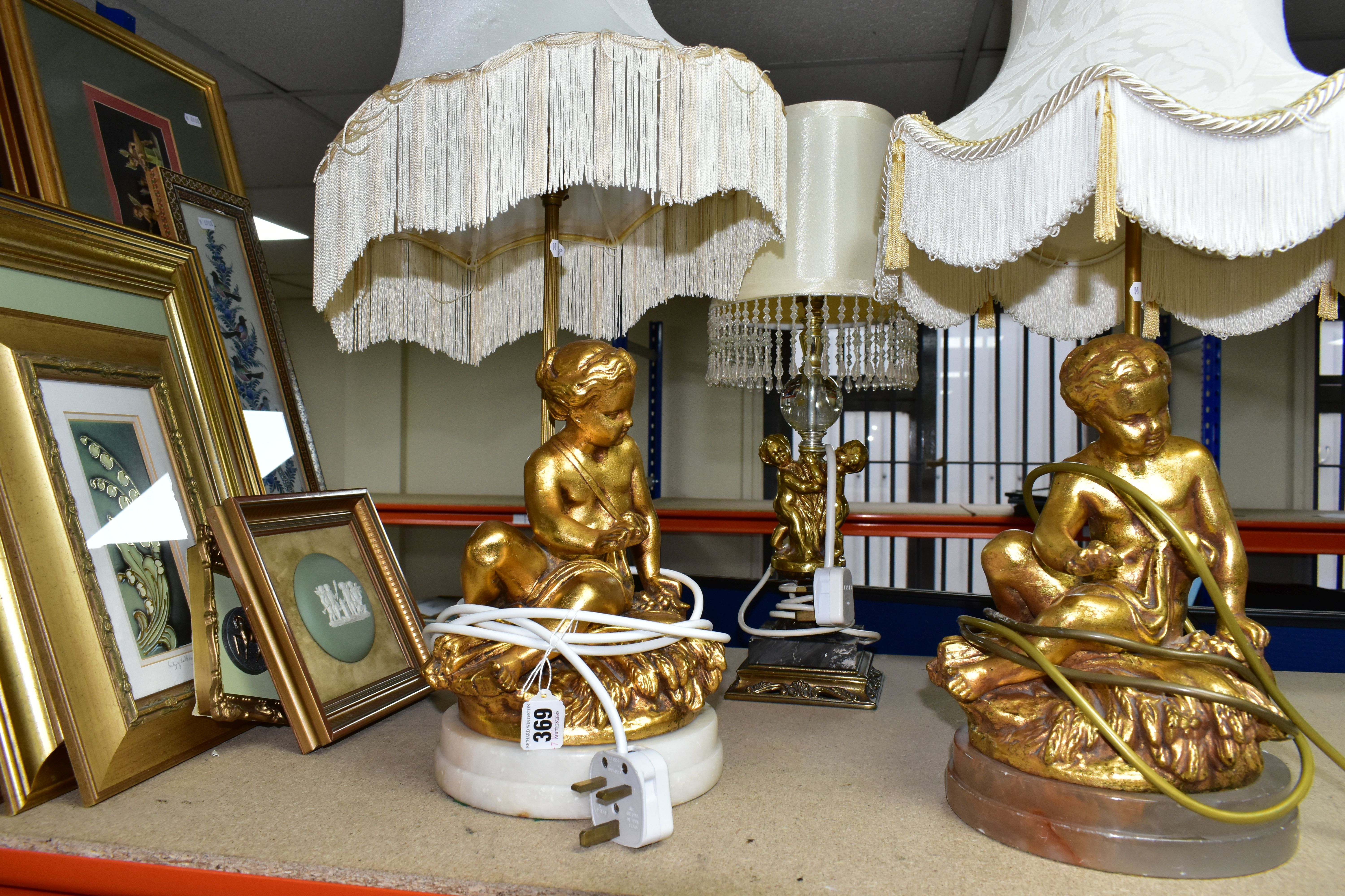 A GROUP OF LAMPS AND GILT FRAMED PRINTS, comprising a small figural standard lamp with cherubs