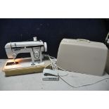 A NEW HOME DELUXE 543210 SEWING MACHINE (PAT pass and working) and a small tubular frame children'