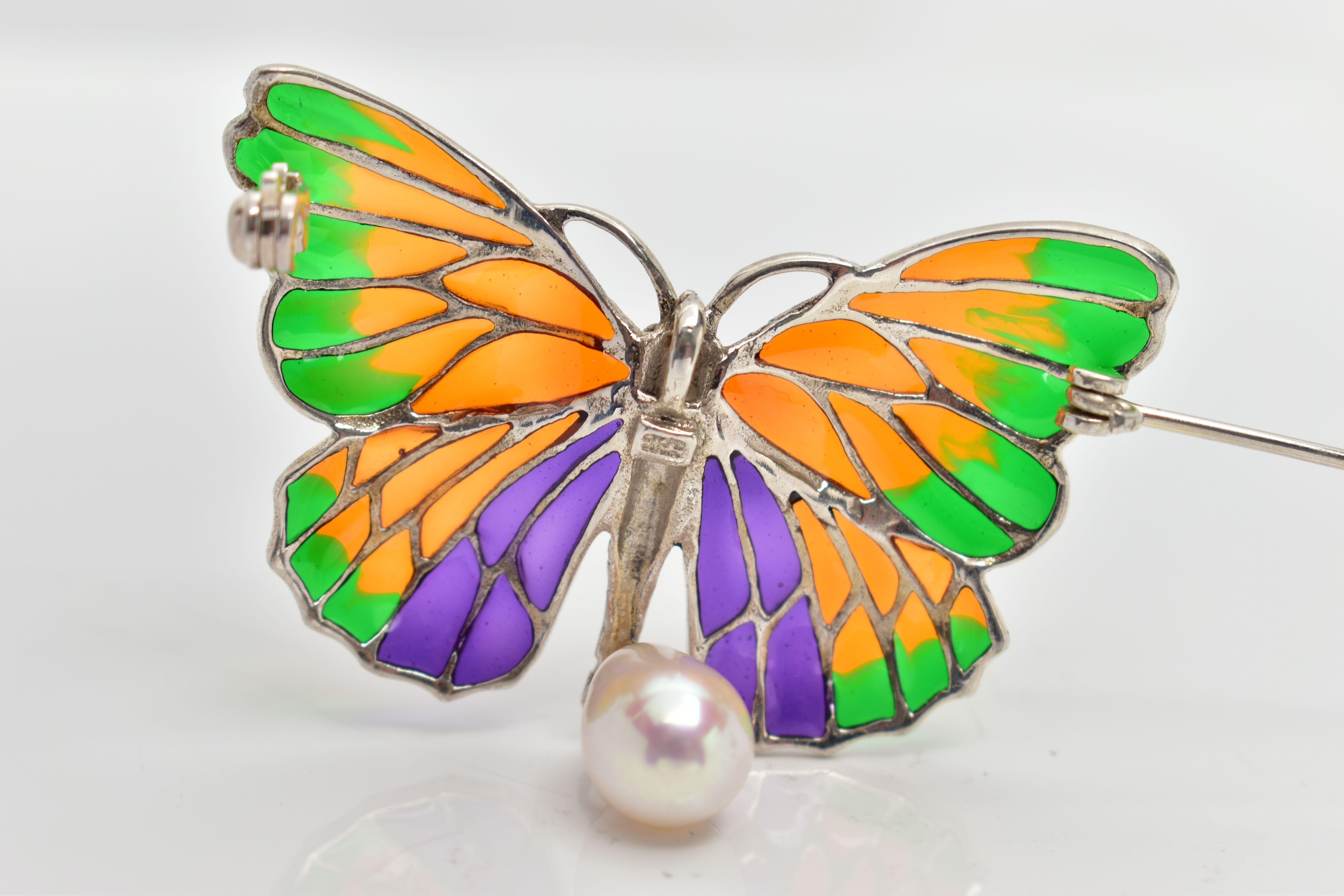 A PLIQUE A JOUR BROOCH, designed as a white metal butterfly, displaying green, orange and purple - Image 2 of 2