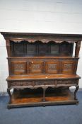 A LATE VICTORIAN SOLID OAK BUFFET, with a fixed overhanging cornice, on block supports, and five