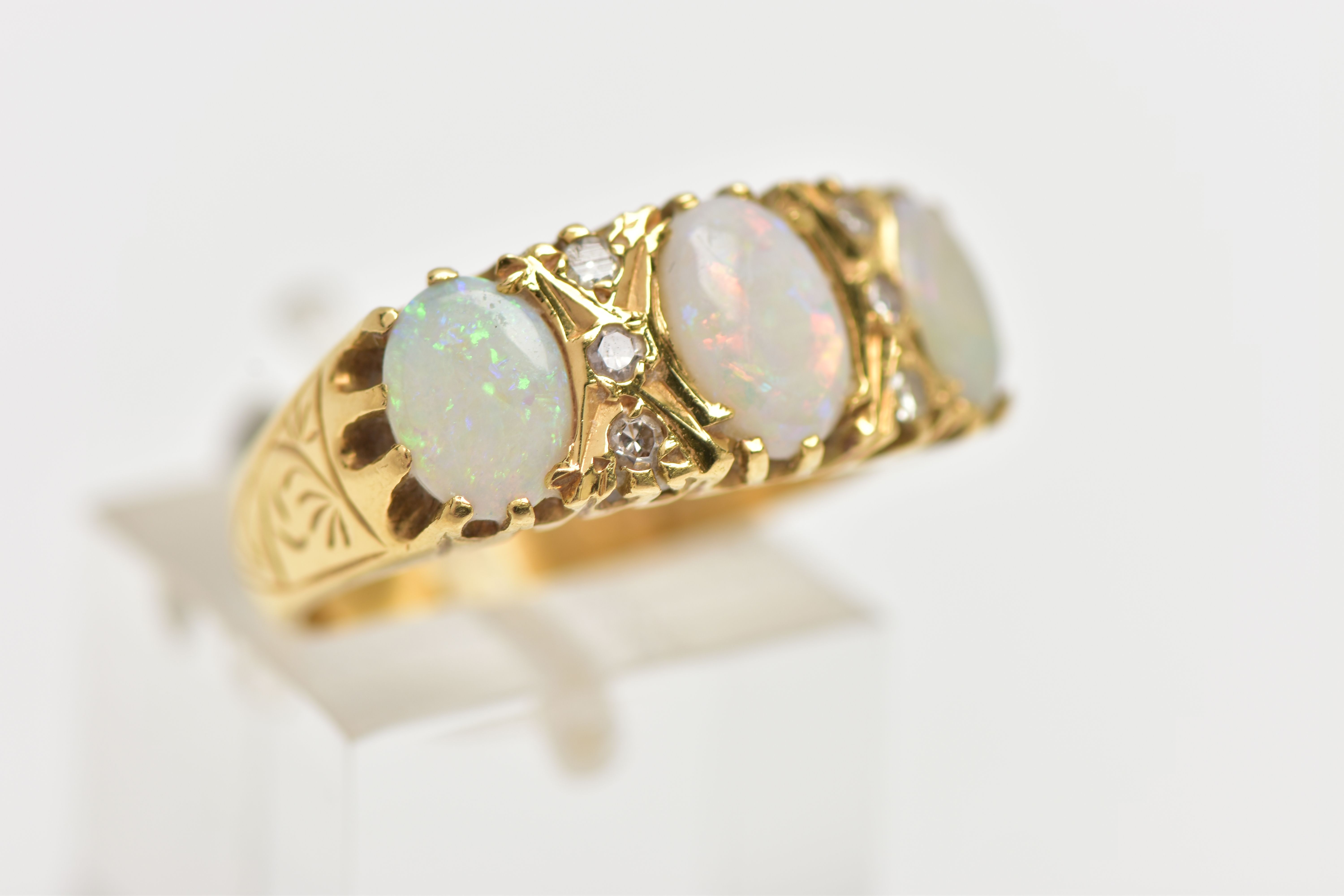 AN OPAL AND DIAMOND RING, set with three oval opal cabochons, interspaced by six single cut - Image 4 of 4