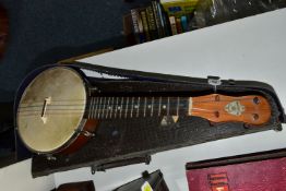 A BARNETT SAMUEL DULCETTA UKULELE BANJO IN DISTRESSED CASE, the banjo has four tuning keys, total