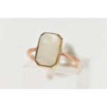 A YELLOW METAL OPAL RING, rectangular cut opal cabochon with cut off corners, milgrain collet mount,