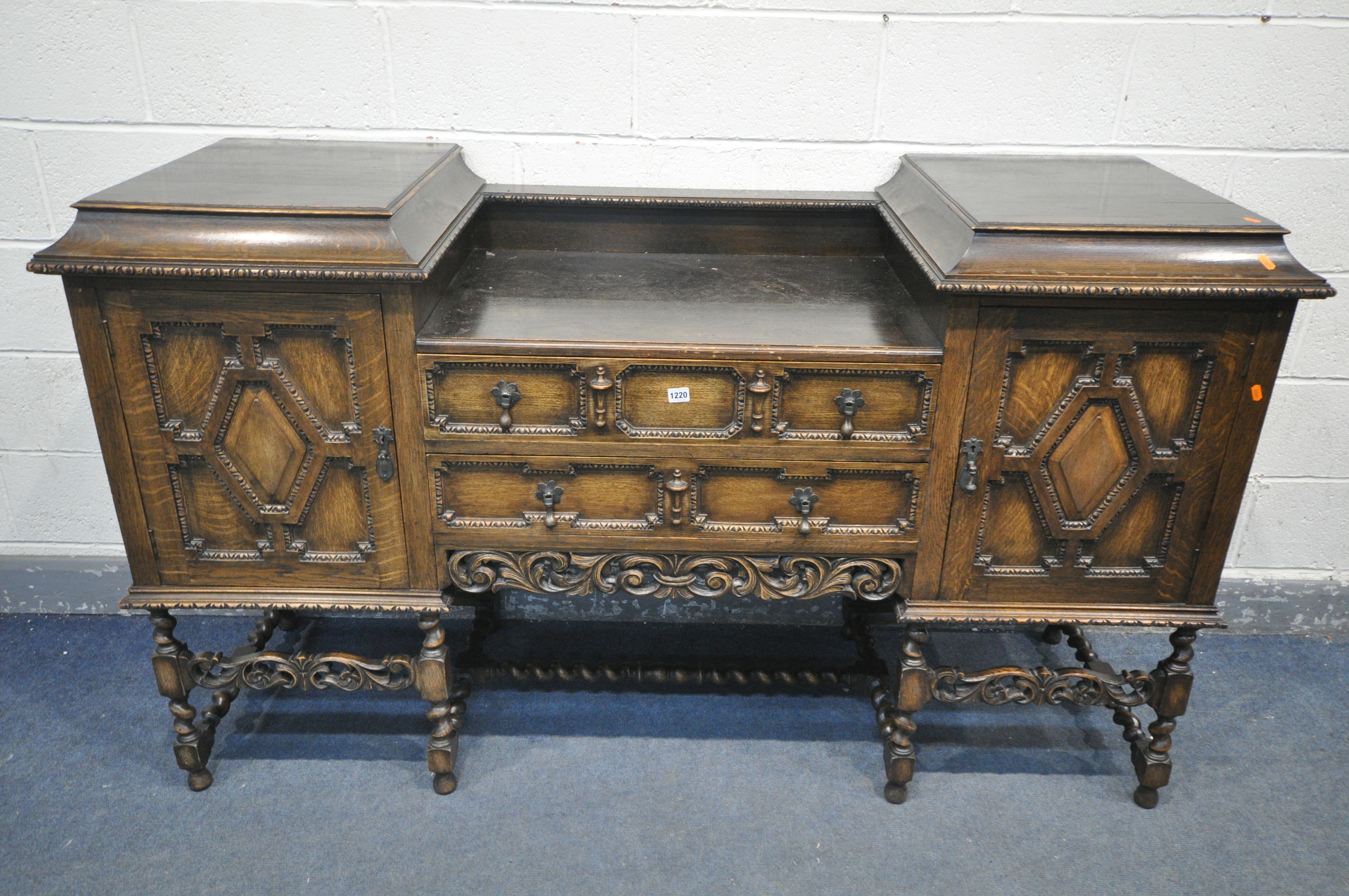 AN EARLY 20TH CENTURY OAK PEDESTAL SIDEBOARD, with geometric doors and drawers, on barley twist legs