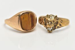 TWO 9CT YELLOW GOLD GEM SET RINGS, to include a ring designed as a lion's head, with a colourless