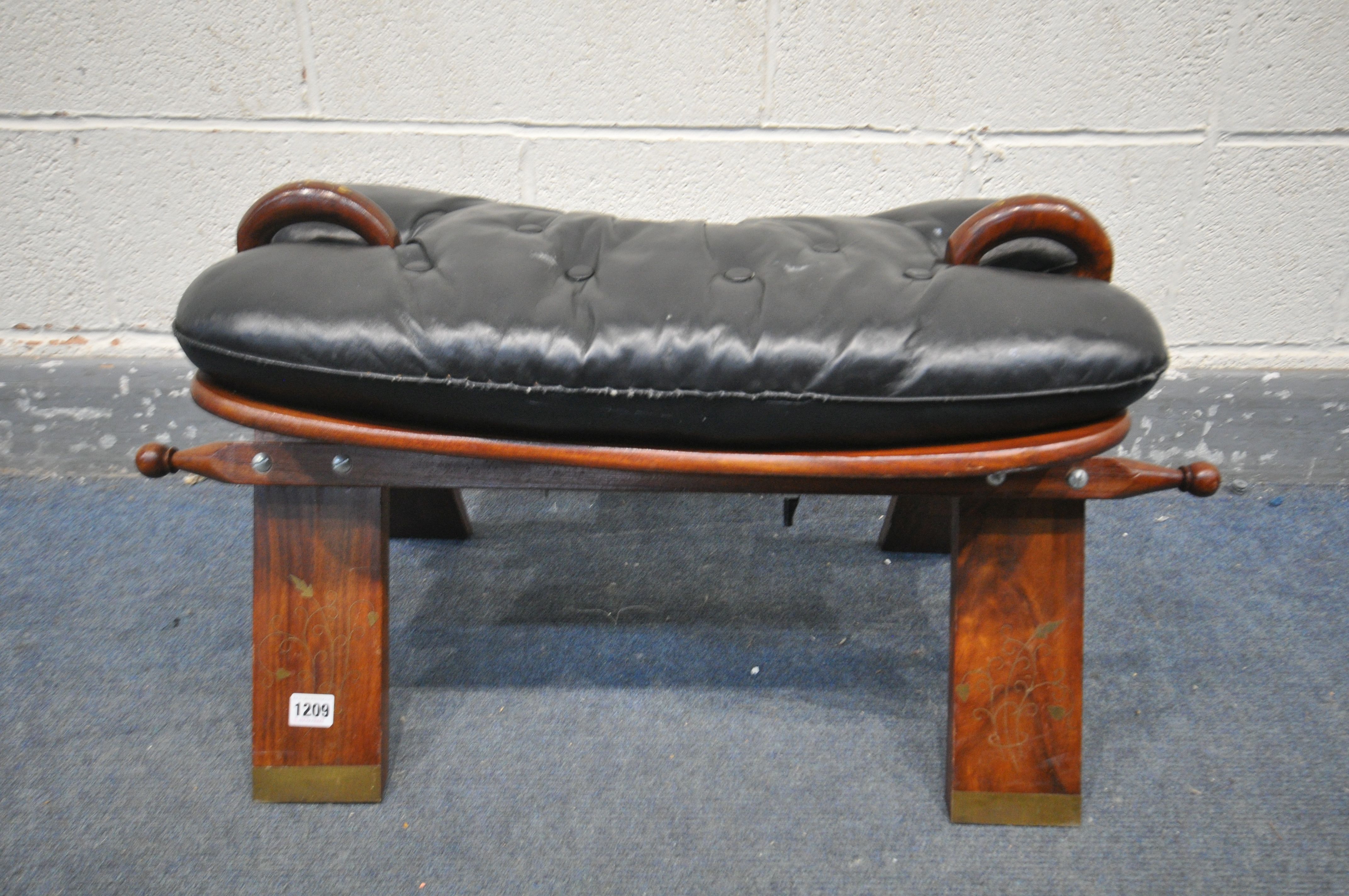 AN INDIAN HARDWOOD AND BRASS INLAID CAMEL STOOL, with a leather cushion - Image 2 of 2