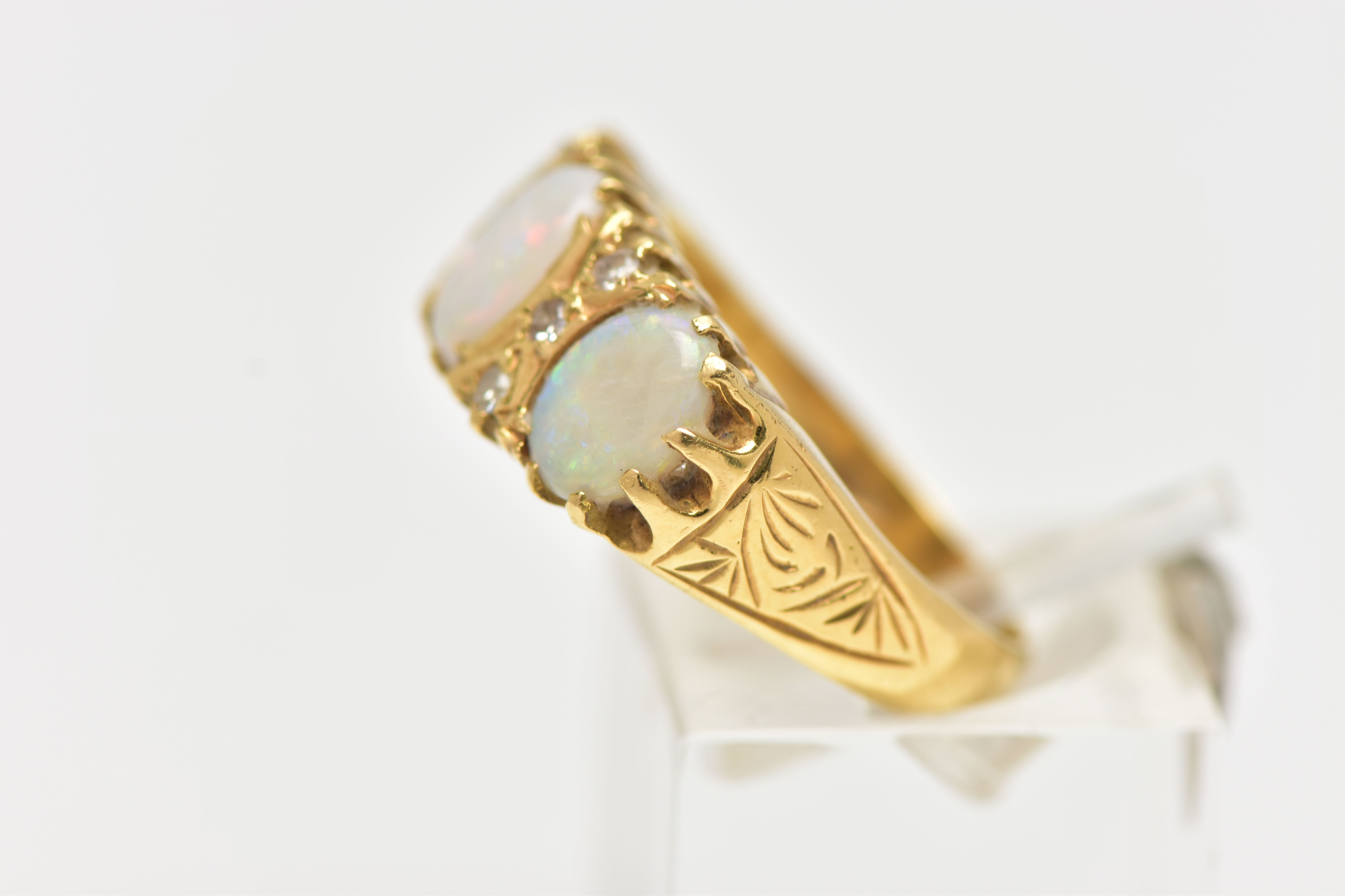 AN OPAL AND DIAMOND RING, set with three oval opal cabochons, interspaced by six single cut - Image 2 of 4