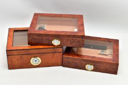 THREE 'GERMANUS' AMBOYNA CIGAR HUMIDOR BOXES, two shallow wooden boxes with an open top glass panel,