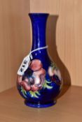 A MOORCROFT POTTERY BUD VASE, tube lined pink and purple Anemone pattern on a blue ground, impressed