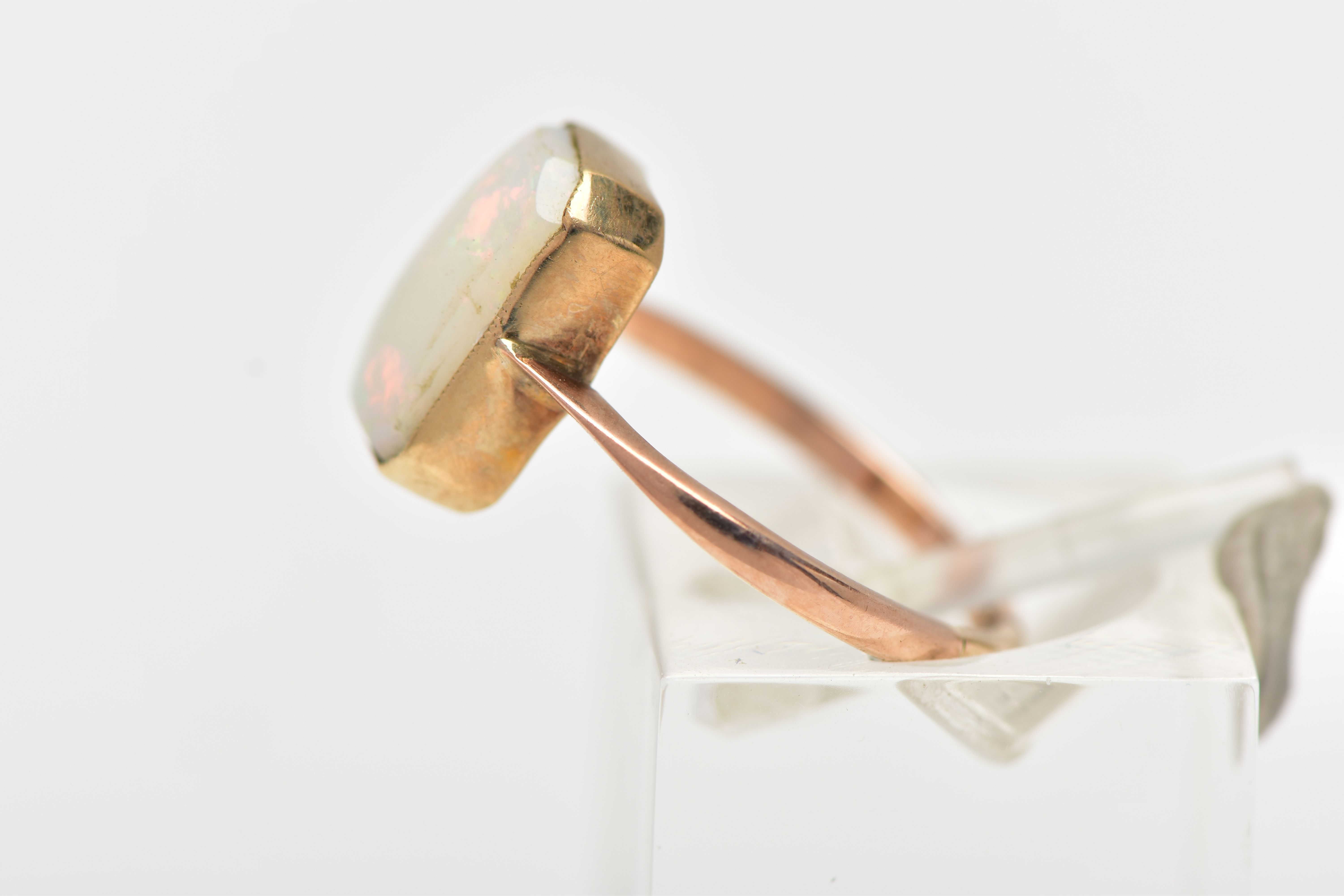 A YELLOW METAL OPAL RING, rectangular cut opal cabochon with cut off corners, milgrain collet mount, - Image 2 of 4