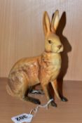 A BESWICK FIGURE OF A SEATED HARE, model no 1025, tan gloss finish, issued 1945-1963, height 18cm,