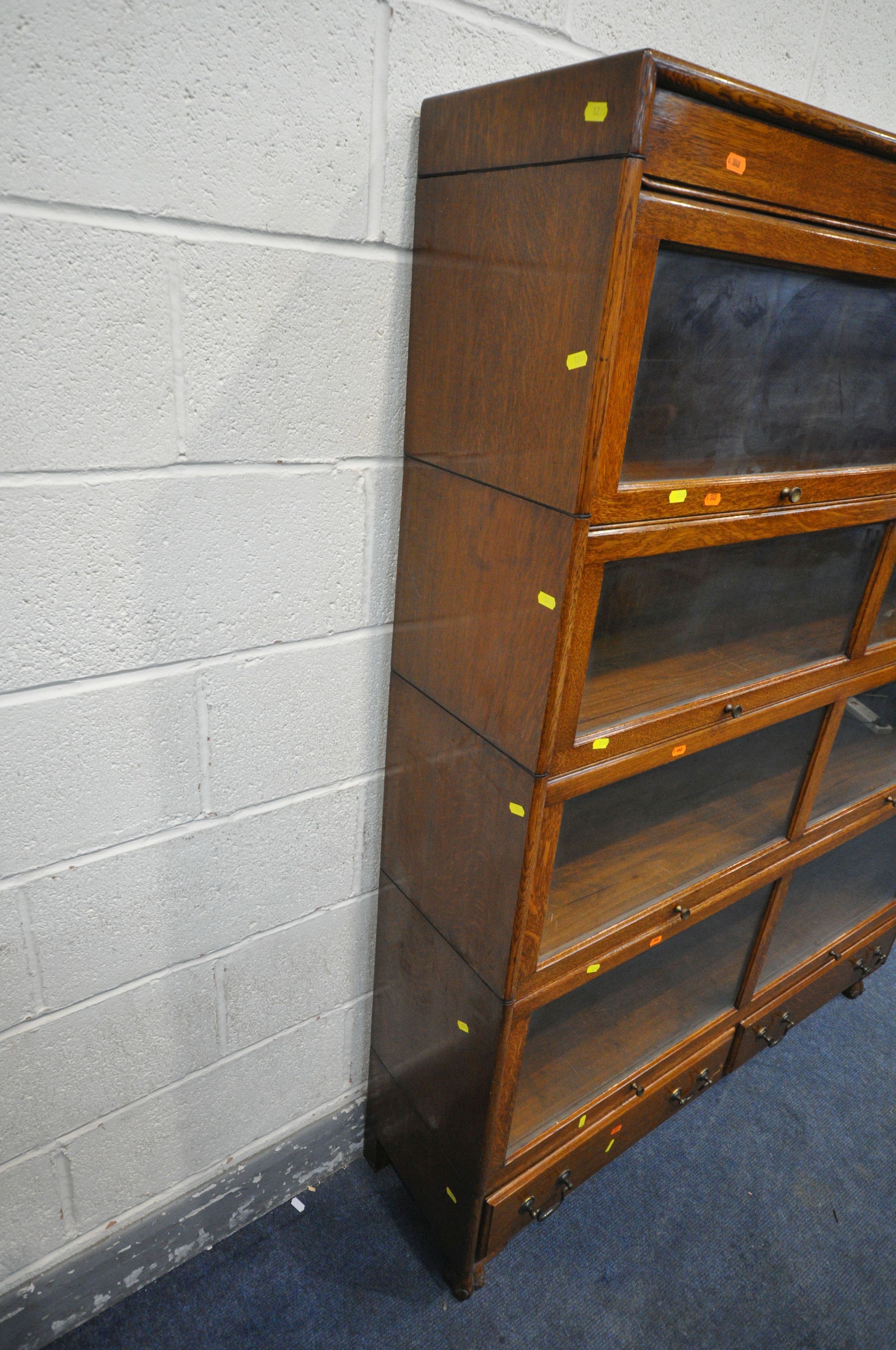 AN EARLY 20TH CENTURY OAK FOUR SECTION BOOKCASE, with twin glazed hide and fall doors, over a base - Image 3 of 3