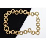 A YELLOW METAL CHAIN NECKLACE, a wide chain comprised of hollow circular filagree links fitted