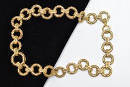 A YELLOW METAL CHAIN NECKLACE, a wide chain comprised of hollow circular filagree links fitted