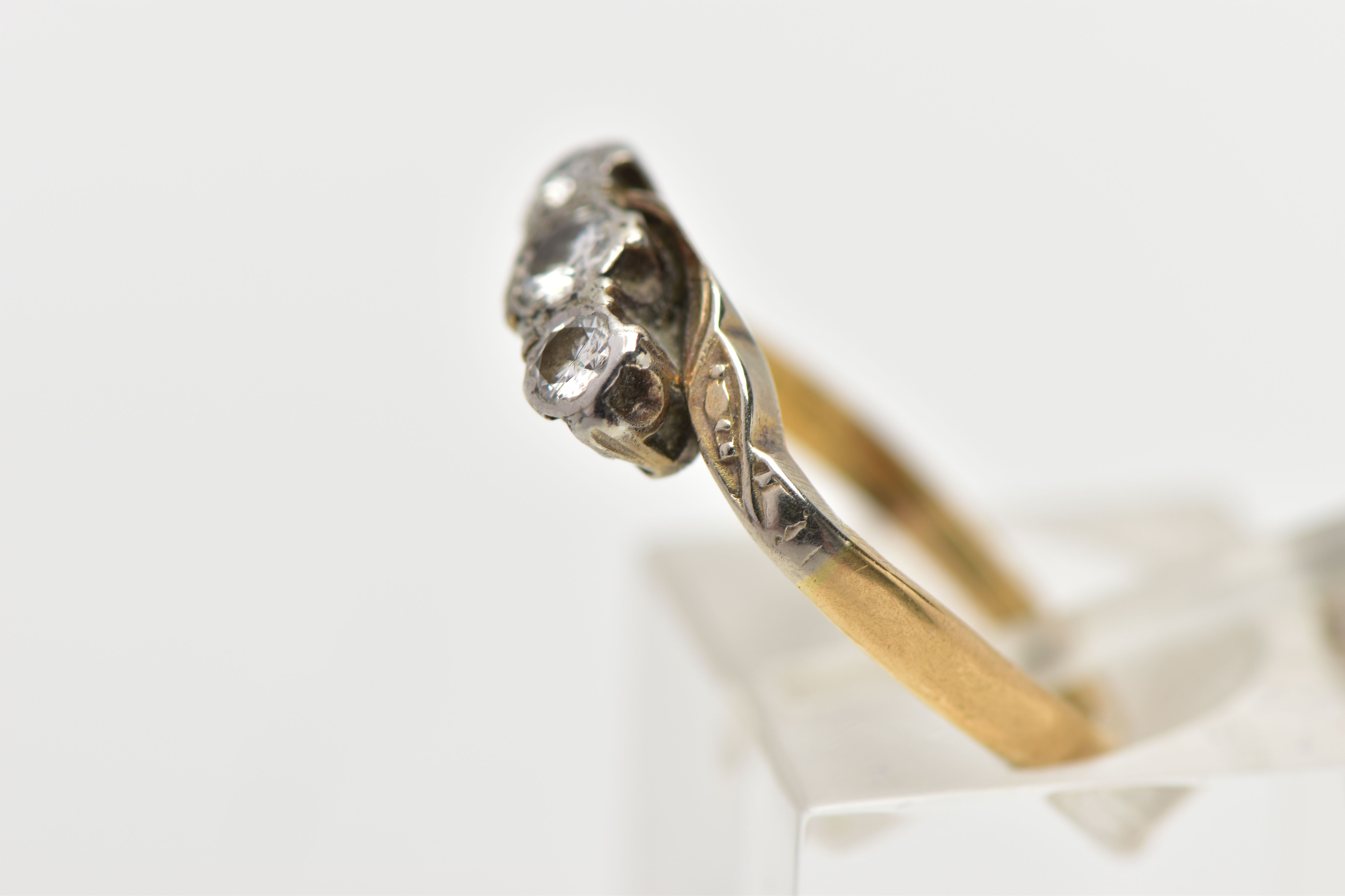 A MID 20TH CENTURY WHITE AND YELLOW METAL DIAMOND THREE STONE RING, set with graduating round - Image 2 of 4