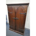 A GOTHIC STAINED PINE TWO DOOR CUPBOARD, width 115cm x depth 59cm x height 176cm (condition:-both