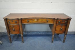 A GEORGE IV WALNUT PEDESTAL SIDEBOARD, with two drawers, above cupboard doors, flanking a single