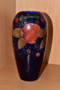 A MOORCROFT POTTERY BALUSTER VASE, tube lined Pomegranate pattern on a navy blue ground, painted and