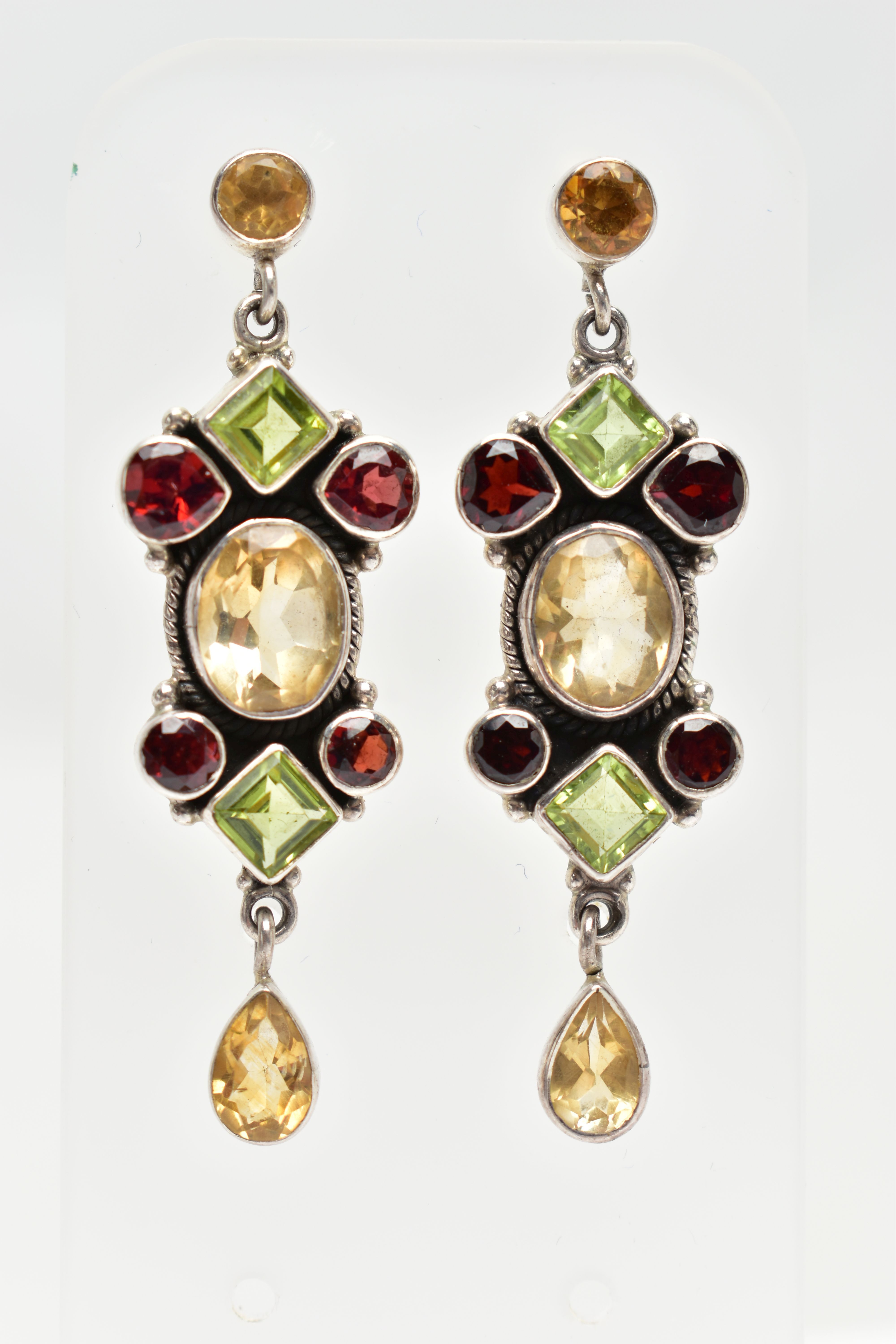 A PAIR OF WHITE METAL GEMSET EARRINGS, a pair of white metal drop earrings set with garnet,