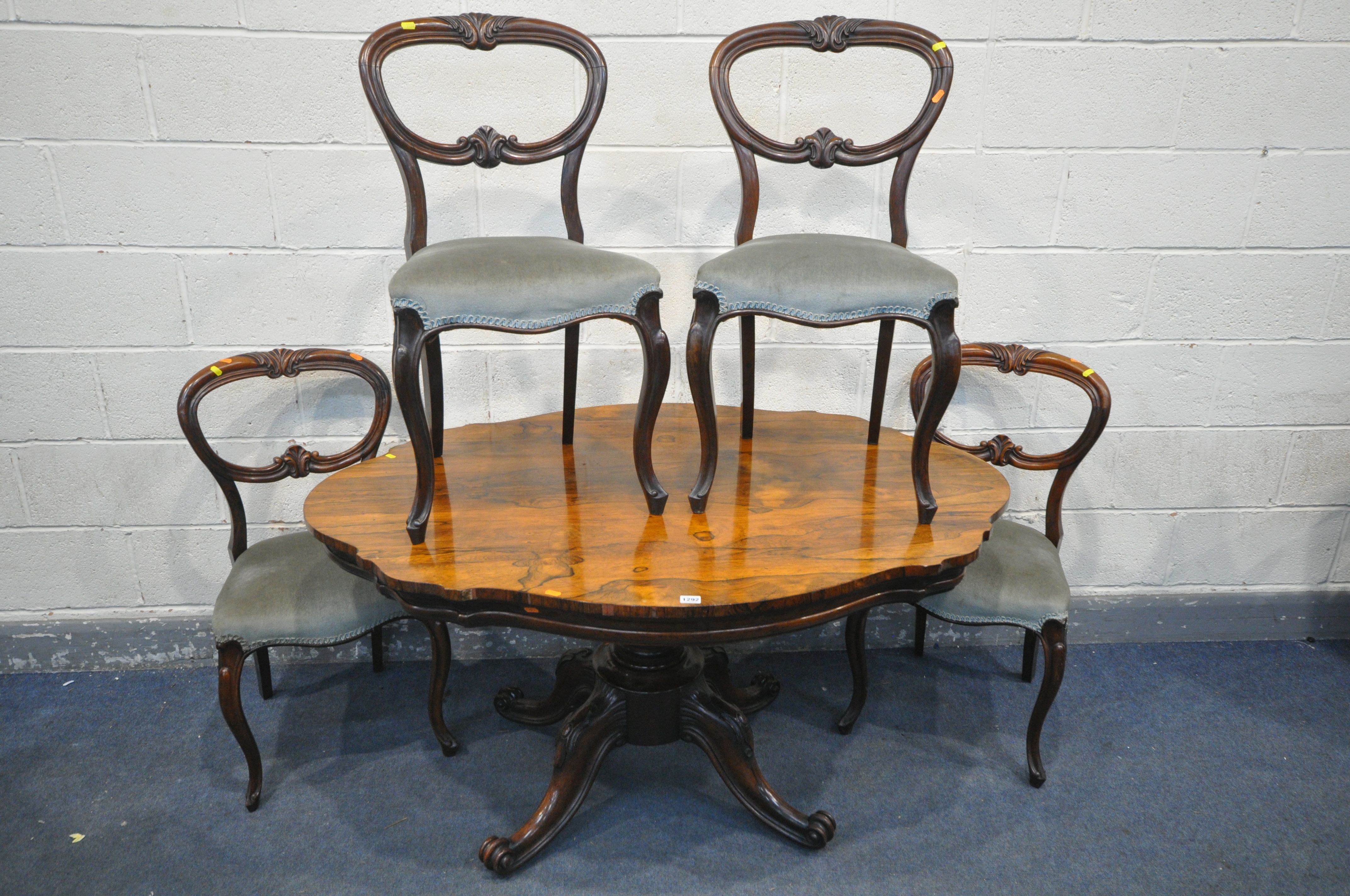 A VICTORIAN ROSEWOOD BREAKFAST TABLE, with a wavy top, on four scrolled legs and casters, length