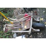 A WOODEN WHEEL BARROW and a quantity of garden tools, spades, forks, rakes, hoes etc..