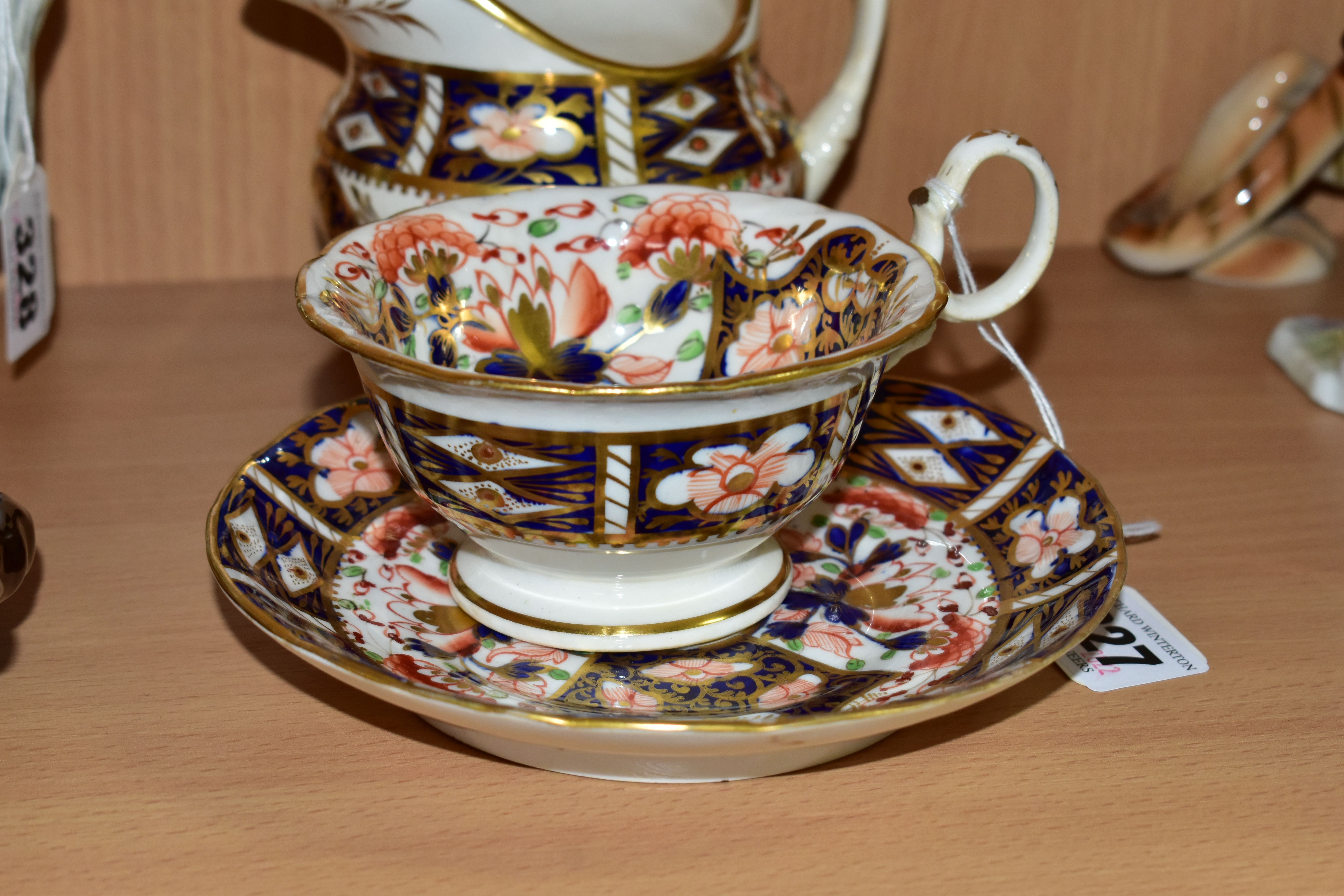 A NINETEENTH CENTURY ENGLISH TEACUP, SAUCER AND CREAM JUG, in an Imari pattern, the teacup having - Image 2 of 4