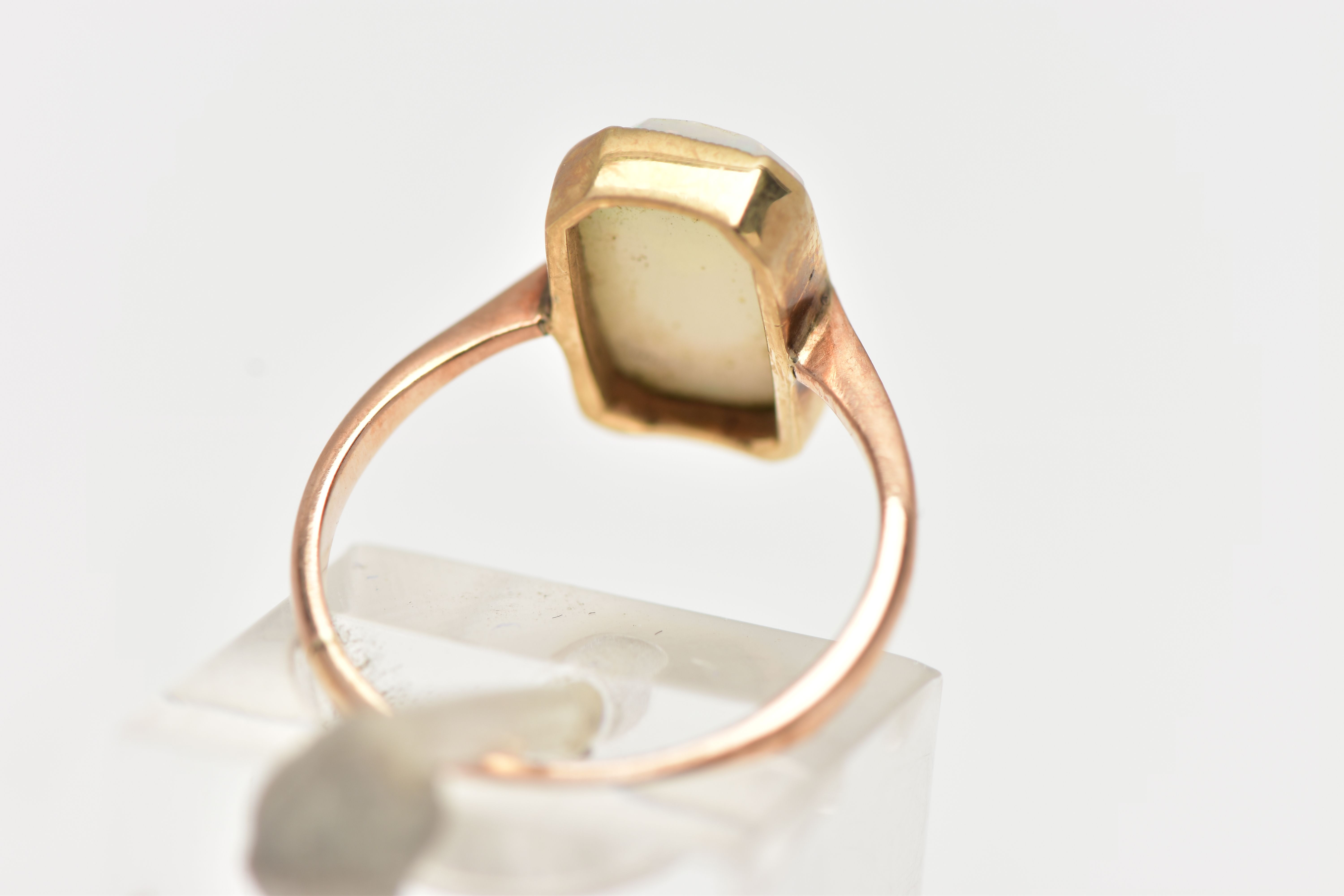 A YELLOW METAL OPAL RING, rectangular cut opal cabochon with cut off corners, milgrain collet mount, - Image 3 of 4