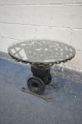 A BESPOKE OCCASIONAL TABLE, made up of mechanic tools and engine parts, with a glass top, diameter
