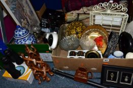 TWO BOXES OF HOUSEHOLD SUNDRIES, to include raffia baskets, small rugs, a Ricoh Mirai zoom camera, a