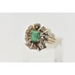 A 1970s EMERALD AND DIAMOND CLUSTER RING, of geometric design, set with a principal rectangular