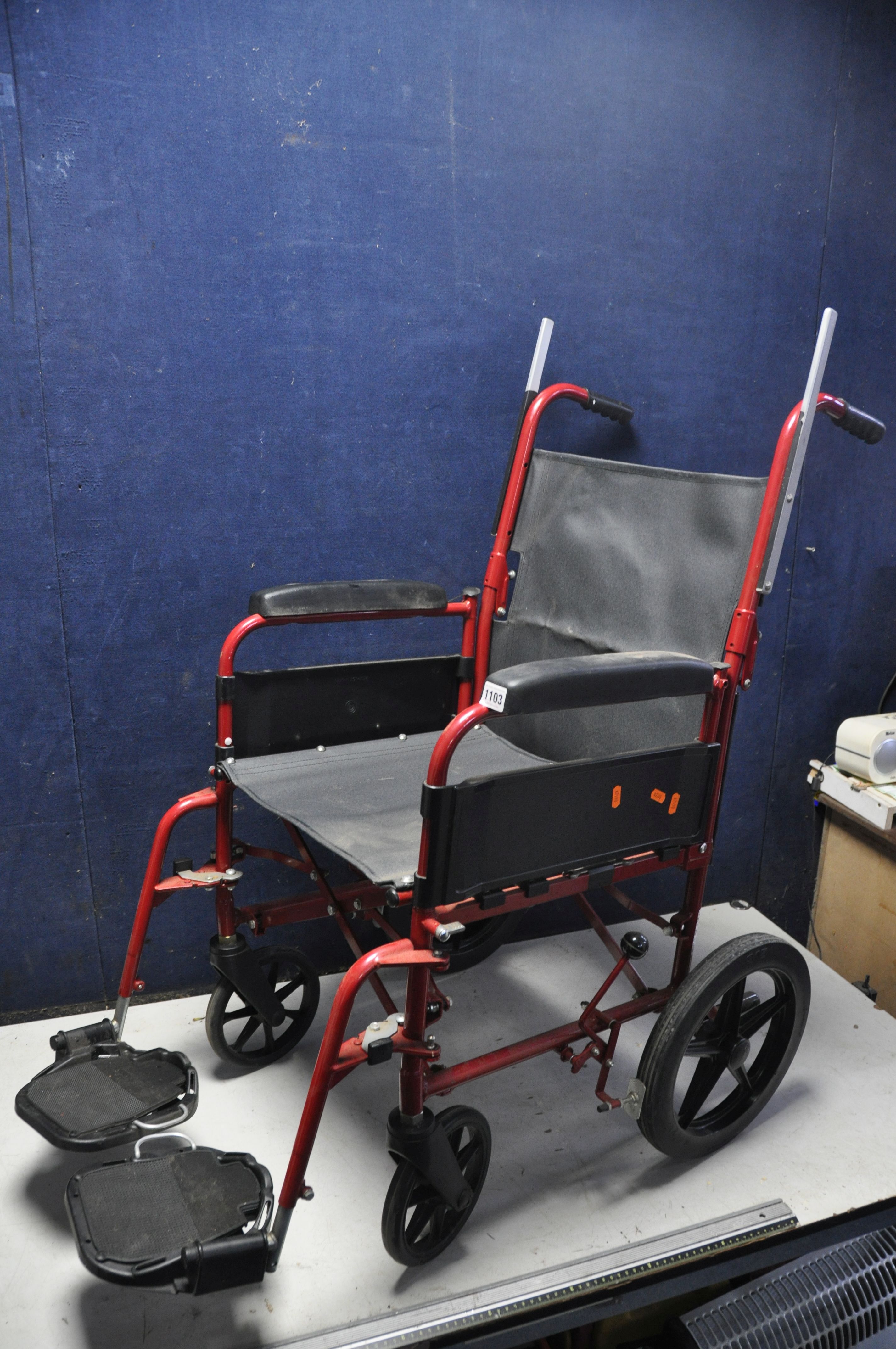 A REMPLOY WHEELCHAIR with no seat pad