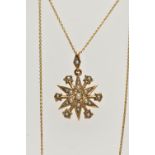 AN EDWARDIAN 15CT GOLD SPLIT PEARL STAR PENDANT WITH CHAIN, the pendant set throughout with split