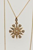 AN EDWARDIAN 15CT GOLD SPLIT PEARL STAR PENDANT WITH CHAIN, the pendant set throughout with split