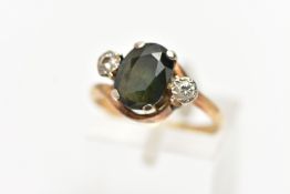 A YELLOW METAL SAPPHIRE AND DIAMOND RING, centering on an oval cut bluish/green sapphire in a four