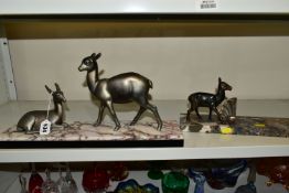 A FRENCH ART DECO SCULPTURE OF TWO DEER, one lying one standing, mounted to a marble base,