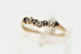 A 9CT GOLD SAPPHIRE AND CUBIC ZIRCONIA WISHBONE RING, set with four circular cut blue sapphires