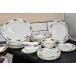 A TWENTY NINE PIECE SAINT JAMES CHINA DINNER SERVICE, comprising a sauceboat and stand, a meat