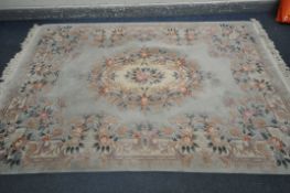 A TEAL CHINESE WOOLEN RUG, with floral border and central design, 284cm x 186cm (condition - in need