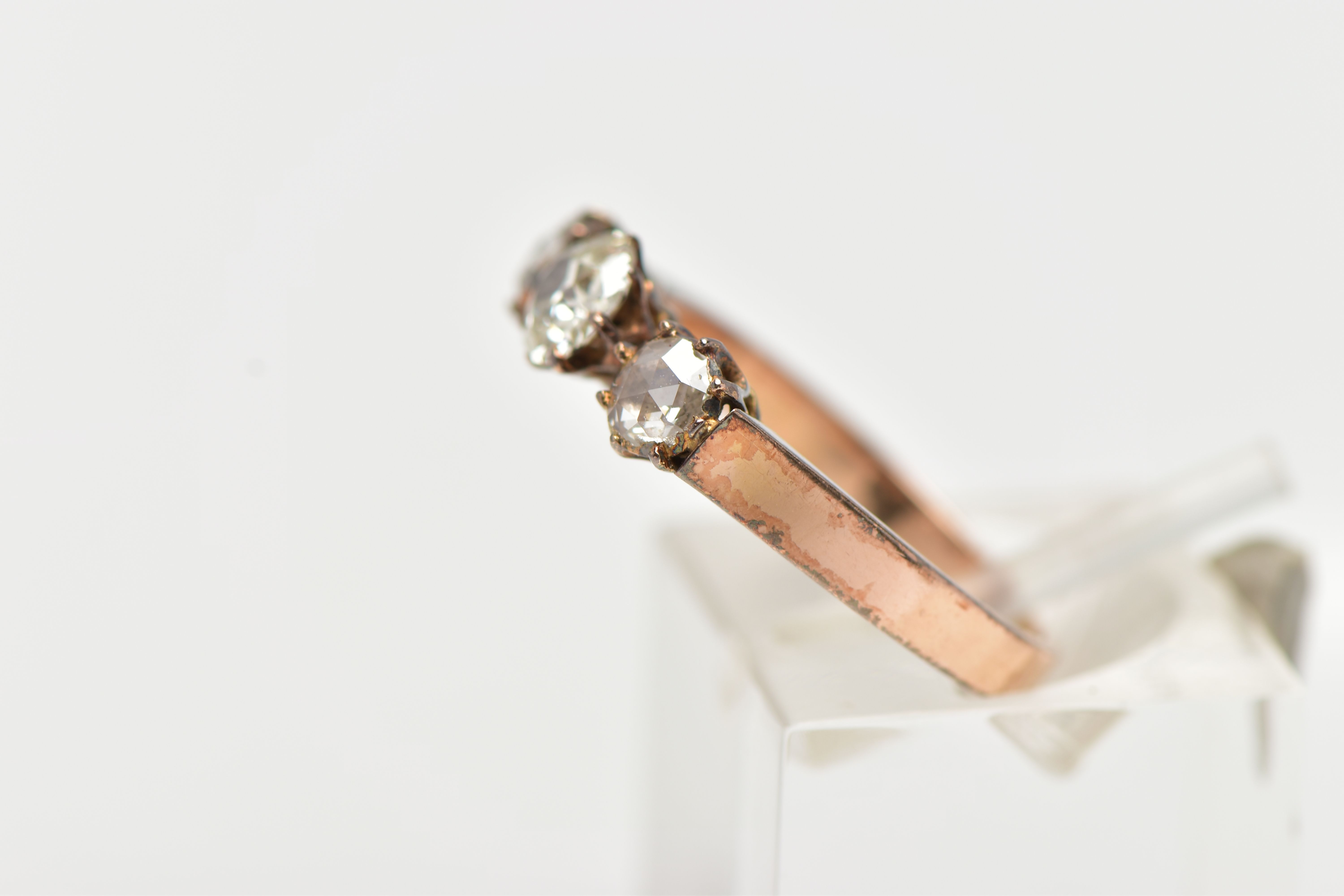 A YELLOW METAL DIAMOND RING, centering on an old cut diamond, and two rose cut diamonds, prong set - Image 2 of 4