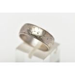 A WHITE METAL WIDE BAND RING, featuring a worn floral engraving, approximate width 6.1mm, stamped