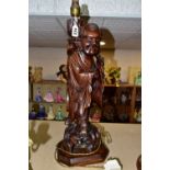 A LARGE WOODEN FIGURAL TABLE LAMP, a hand carved figure of Chinese Shou Lao (god of Longevity),