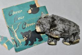 A T.N. CLOCKWORK 'CLEVER BEAR' TOY, made in Japan, height 6.5cm x length 12cm, with partial box (